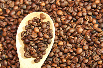 coffee beans background in a wooden ladle 