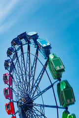 Colorful ride in motion in amusement park on sky background.