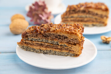 Walnut and hazelnut cake with caramel on blue wooden. side view, copy space, selective focus.