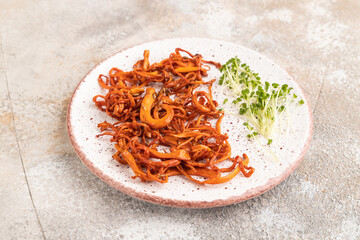 Fried Cordyceps militaris mushrooms on brown concrete. Side view, copy space.