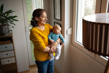 Senior adult woman with her grandchild little baby boy