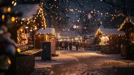 Foto auf Leinwand A snowy street with people walking and a Christmas market © XtravaganT
