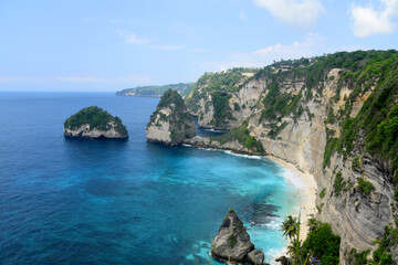 Diamond Beach, at Nusa Penida island of Bali, with beauty white cliff formation and white sand beach during day time