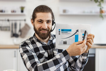 Smiling entrepreneur presenting marketing report on online meeting from home workplace. Portrait of...