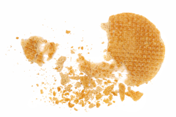 Broken dutch waffles with caramel isolated on white background, top view
