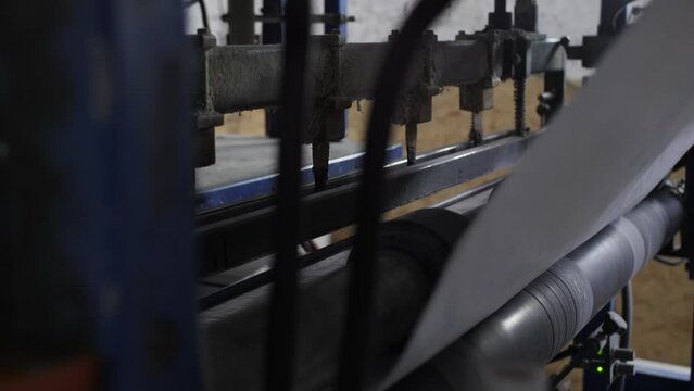 The machine cuts polyethylene with a hot blade