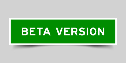 Square sticker label with word beta version in green color on gray background
