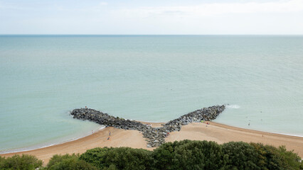  Looking down on rocky sea defences and breakwaters on Mermaid Beach from the The Leas in Folkestone, Kent, UK.