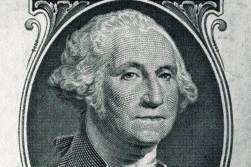 George Washington face in the frame on a one dollar bill. United States national currency banknote fragment. George Washington's portrait on the one dollar bill