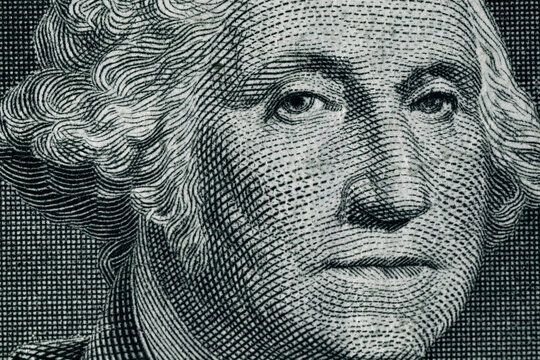 George Washington's face on a one dollar bill. United States national currency banknote fragment. George Washington portrait