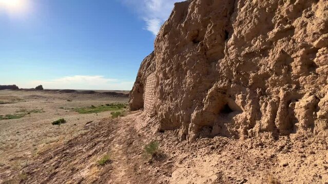 Turkestan walls of the ancient city of Sauran on a sunny day with a blue sky. Ancient buildings, fortress, ruins, ancient architecture in the settlement of Sauran. Archaeological excavations.