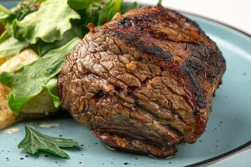 Portion of grilled beef mignon steak with vegetables