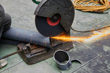 A sliding compound mitre saw with circular blade for cutting steel pipe