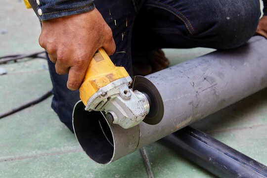 A sliding compound mitre saw with circular blade for cutting steel pipe