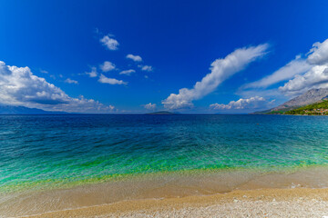 Fototapeta na wymiar Empty beach azure water Adriatic sea Makarska Riviera