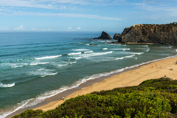 Atlantic Ocean, rocky cliffs and sandy beach in Portugal