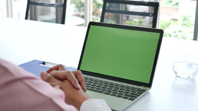 Closeup businessman hands working use laptop green screen finance business document reading report at office desk. Man hands type keyboard write on office note look at computer monitor