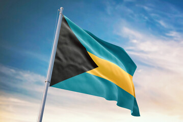 Fototapeta premium Waving flag of Bahamas in blue sky. Bahamas flag for independence day. The symbol of the state on wavy fabric.