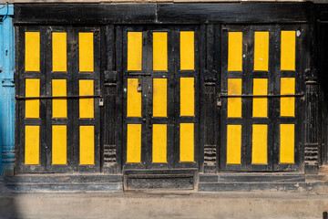 Closed Black and Yellow Wooden Doors