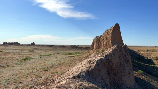 Turkestan walls of the ancient city of Sauran on a sunny day with a blue sky. Ancient buildings, fortress, ruins, ancient architecture in the settlement of Sauran. Archaeological excavations.