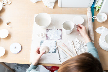 Close-up Image of female hands working with clay mug and making Ceramic Product. Professional...