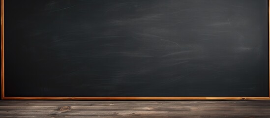 A rectangular blackboard with a wooden frame lays on the hardwood flooring under a cumulus...