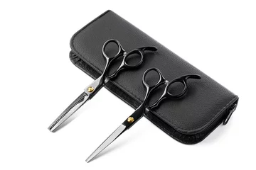 Foto op Plexiglas Hairdressing scissors with leather case on white background © fotofabrika