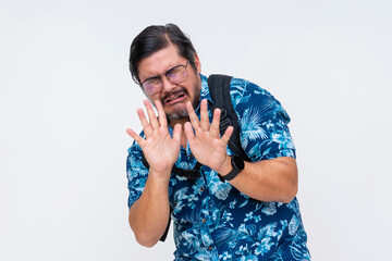 A cowardly middle-aged man in a Hawaiian shirt crying looking scared, pleading with hands up....