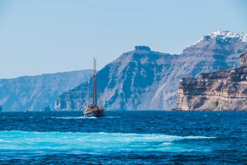 Foto auf Glas tourist vintage sailing yacht in the Aegean sea near the coast of Santorini island in Greece   © Alesia