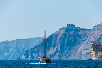 tourist vintage sailing yacht in the Aegean sea near the coast of Santorini island in Greece	