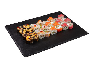 Sushi set served on black stone tray. Various types of sushi rolls served on a slate slab. Isolated on white.