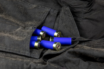 Shotgun Cartridges Spilling from an Outdoor Field Jacket Pocket - 761447065
