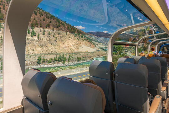 Passengers sitting inside the 360 degrees panoramic train carriage with Fraser River view, Rocky Mountaineer train, Canada.