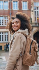 Fototapeta premium Smiling student with backpack outside college building