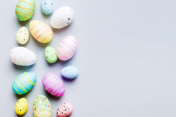 decorative easter eggs on colored background. easter eggs collection top view with copy space