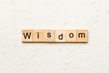 wisdom word written on wood block. wisdom text on table, concept