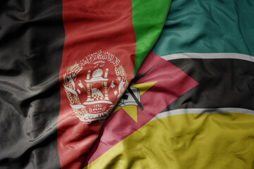 big waving national colorful flag of mozambique and national flag of afghanistan.
