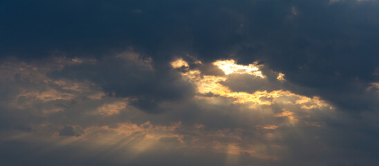 Dark gray clouds and sunlight at the sunset. - 761462860