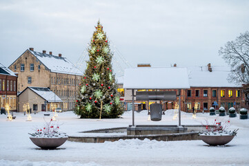  A Christmas tree decorated with ornaments and garlands of lights in the city square, Dobele, Latvia