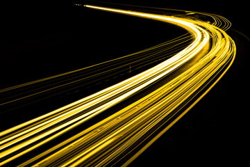 gold car lights at night. long exposure