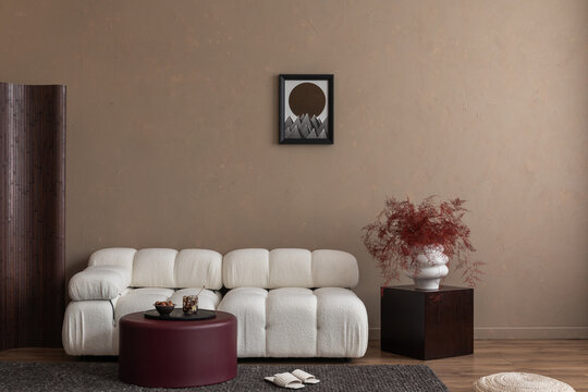 Interior design of modern living room interior with white boucle modular sofa, round coffee table, cube, mock up poster frame, furnitures and elegant decoration. Template. Home decor.	
