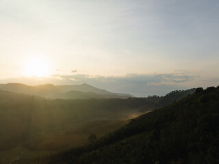 Fototapeta na wymiar Aerial mountain peak sunrise tropical rainforest sky with cloud