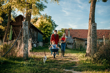 Content family savoring the warmth of the sun while embracing the countryside's natural beauty