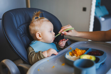 Baby food for 6 months, the boy eats mashed food. Child development.