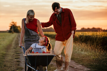 A happy family embraces the tranquility of rural life during the sunset hours