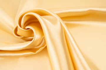 Selective focus abstract image of gold color silk.