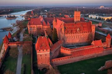 Malbork castle over the Nogat river at sunset, Poland - 761487241