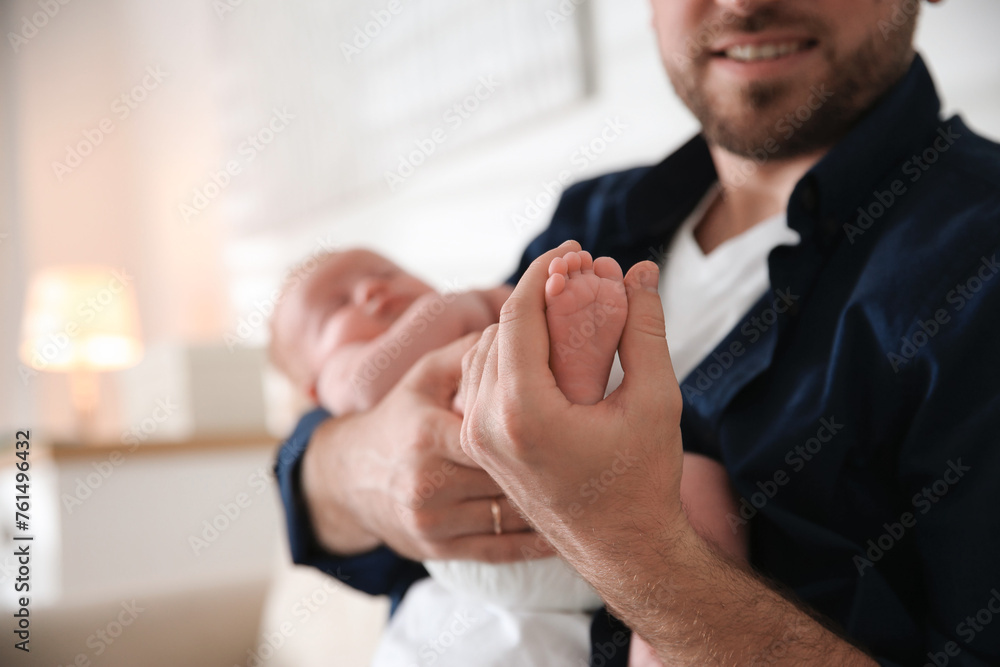 Wall mural father with his newborn son at home, closeup