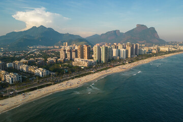Fototapeta premium Aerial View of Barra da Tijuca Beach With Condos and Mountains in the Horizon in Rio de Janeiro, Brazil