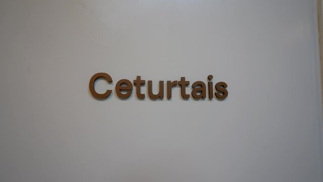 Cesis, Latvia - February 14, 2024 - The image shows a white wall with the word "Ceturtais" in brown, three-dimensional letters, which likely indicates a room or floor number in Latvian.
